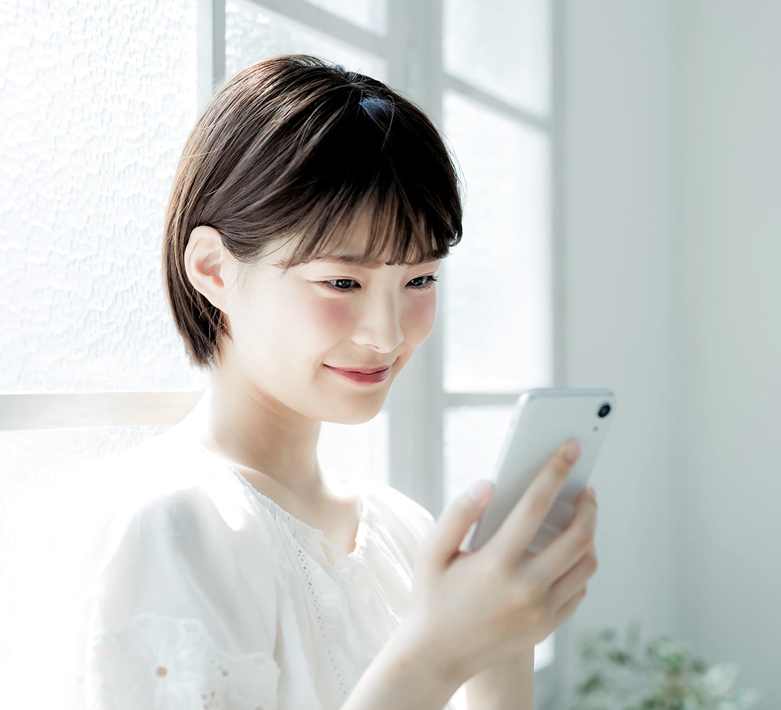 Young asian woman using a smart phone. Mobile communication.